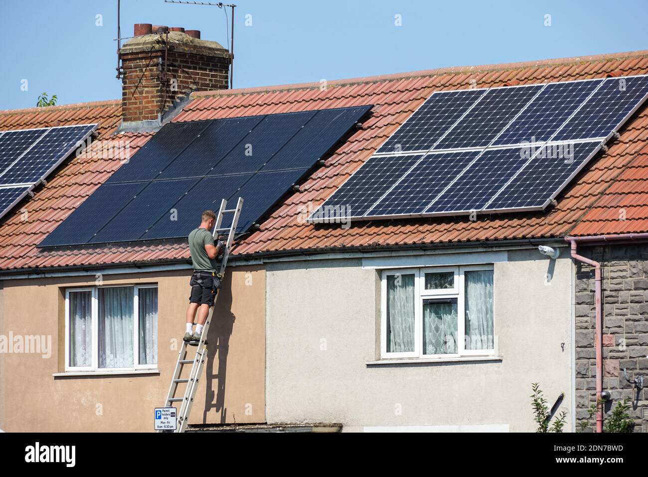 Installation of photovoltaic solar panels on the roof of terraced house in London England United Kingdom UK Stock Photo