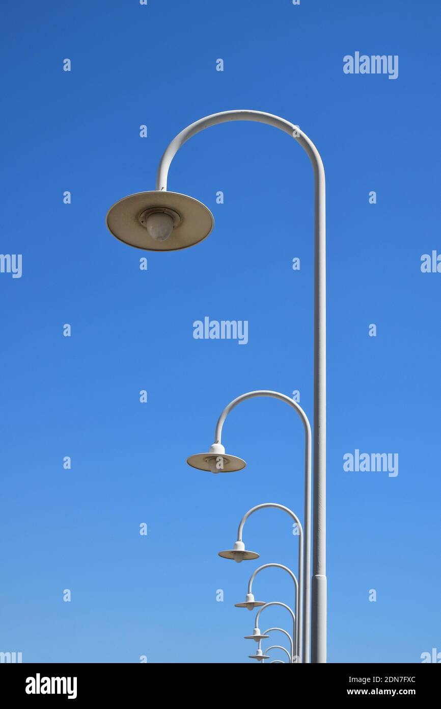 Low Angle View Of Street Lights Against Clear Blue Sky Stock Photo