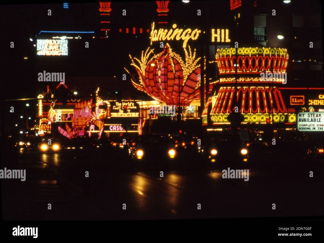 Cars passing the Flamingo Hotel on the Strip in Las Vegas at night. Stock Photo