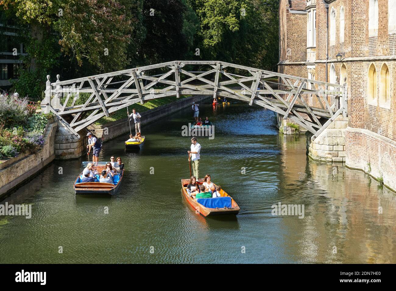 Tourists on punts on the River Cam under Mathematical Bridge in Cambridge Cambridgeshire England United Kingdom UK Stock Photo
