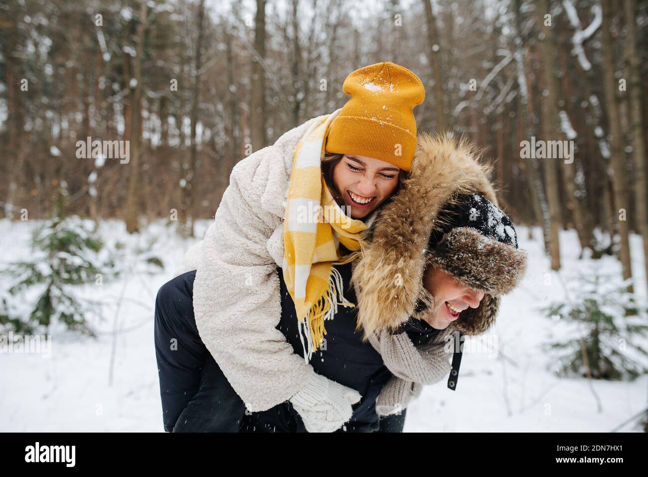Family couple having fun in the winter forest Stock Photo