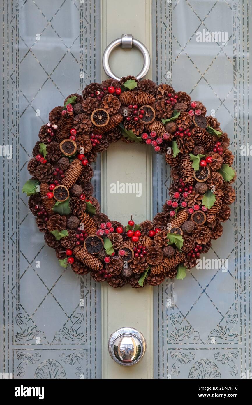 Decorative Christmas wreath on a front door, London England United Kingdom UK Stock Photo