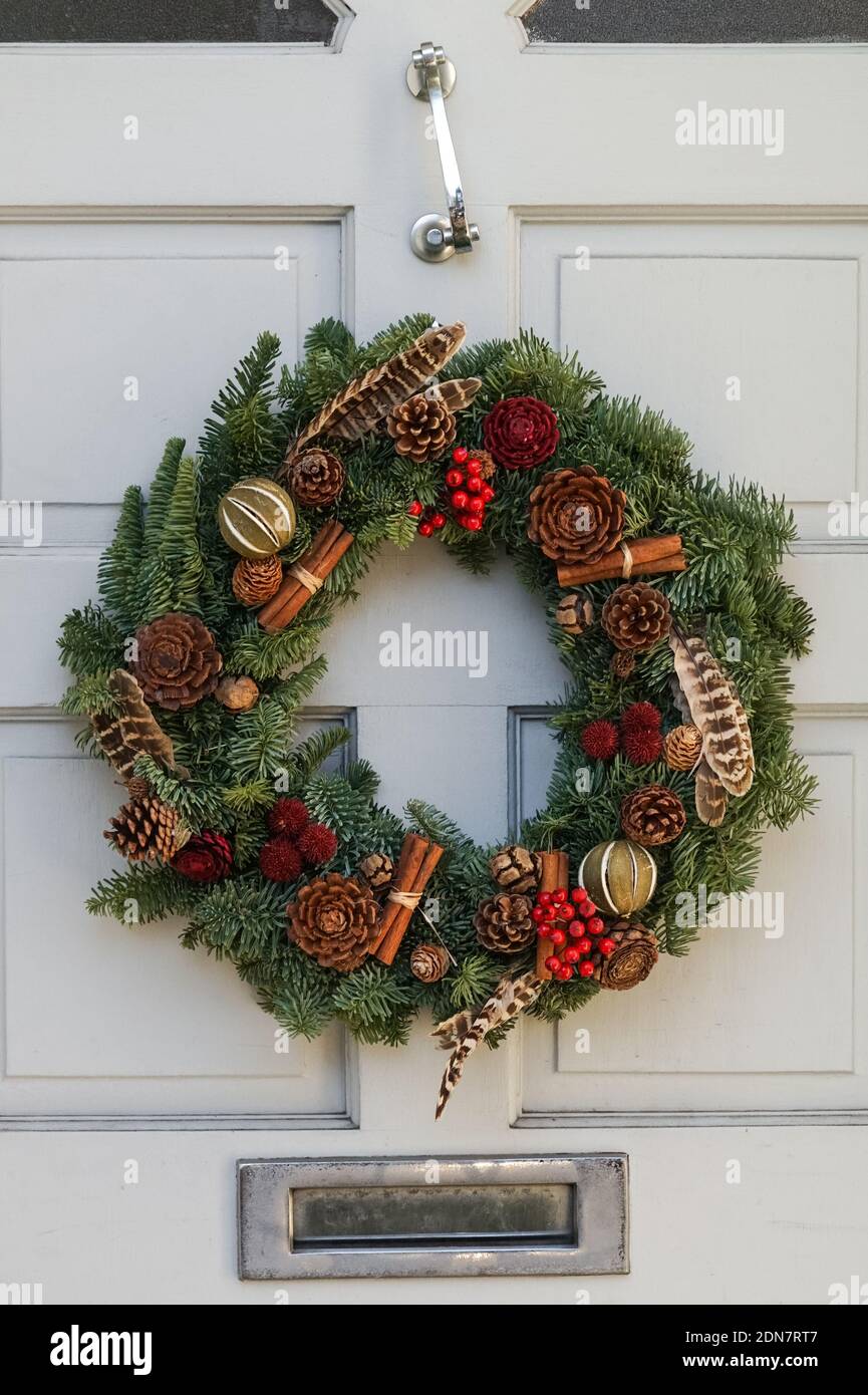 Decorative Christmas wreath on a front door, London England United Kingdom UK Stock Photo