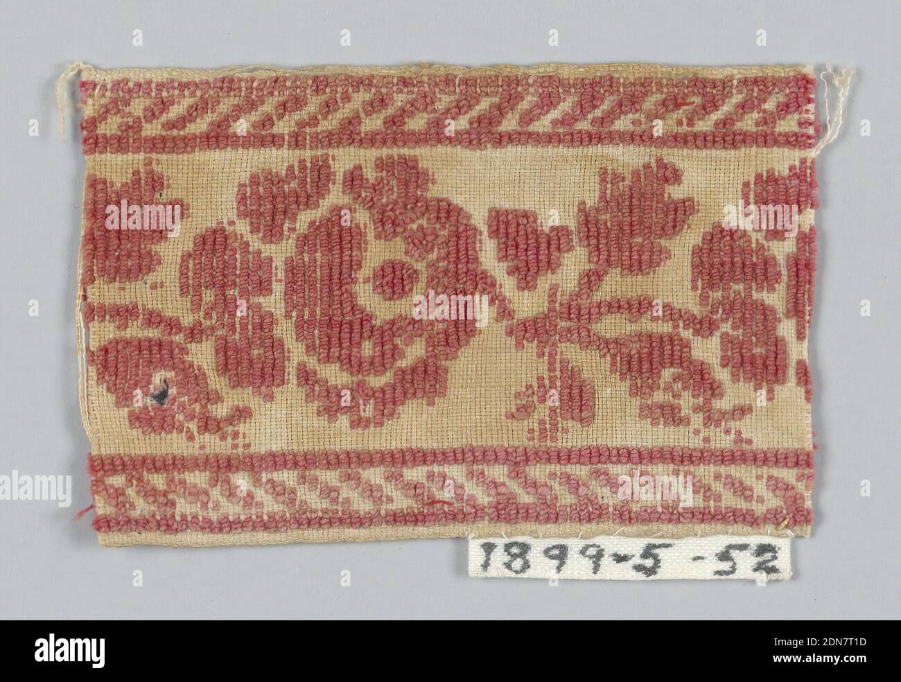 Fragment, Medium: cotton Technique: woven, Fragment has a design of red roses with buds and leaves set between upper and lower borders of diagonal lines on a tan ground., France, ca. 1830, trimmings, Fragment Stock Photo