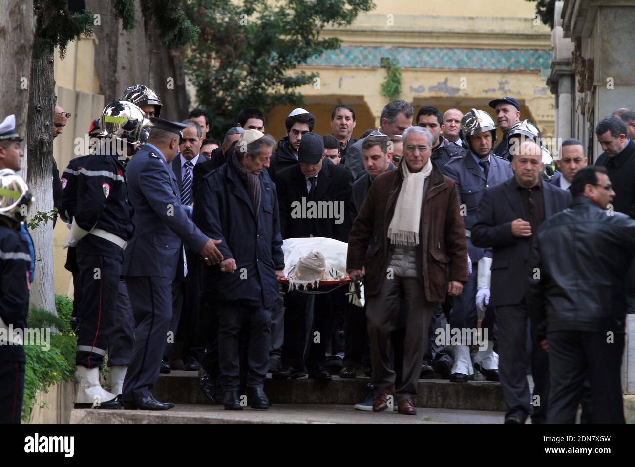 Mourners and relatives, including film director Alexandre Arcady (2ndR), follow the body of French actor Roger Hanin during his funeral at St Eugene Jewish cemetary in the Algerian capital Algiers on February 13, 2015. Hanin, who died on February 11, 2015 in Paris, was best known for playing the title role in the 1989–2006 TV police drama, Navarro. Hanin had prepared his funeral before his death and asked the Algerian authorities to be buried in Algiers, his hometown and in the cemetary where his father rests. Photo by Bilal Bensalem/APP/ABACAPRESS.COM Stock Photo