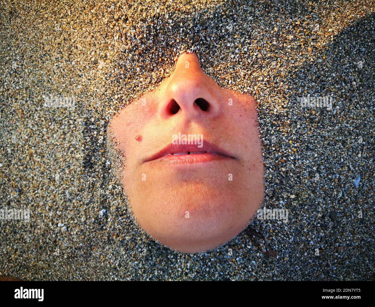 Woman buried in sand beach hires stock photography and images Alamy