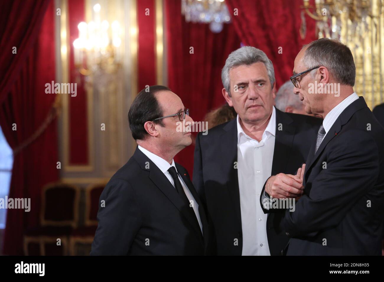 French President Francois Hollande (L) speaks with Claude Onesta (C), the head coach of the French National Handball team and Joel Delplanque, the president of the French Handball Federation during a reception hosted by President Hollande at the Elysee Palace to mark the victory of the French National Handball team in the 2015 World Men's Handball Championship held in Qatar, in Paris, France on February 3, 2015. Photo Pool by Hamilton/ABACAPRESS.COM Stock Photo