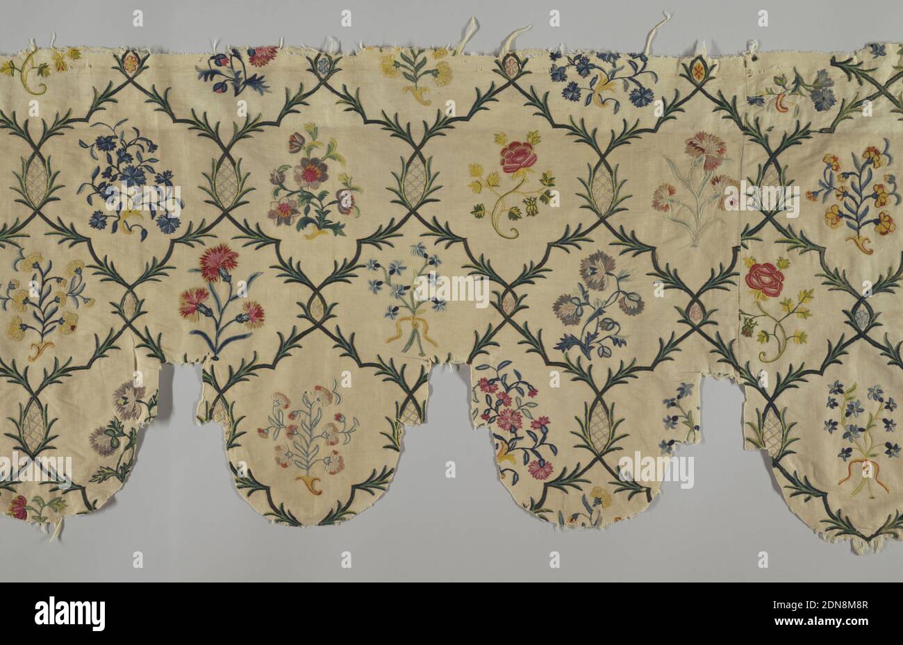 Valance, Medium: cotton, wool Technique: chain stitch embroidery on plain weave, Textile cut and pieced to form a valence with deep rounded scallops. Branches interlace to form a rounded lattice design, each ogive framing a small naturalistic spray of roses, forget-me-nots, carnations, etc. Colors are bright and with many variations of blue, green, yellow, pink and violet on an off-white ground., France, late 18th century, embroidery & stitching, Valance Stock Photo