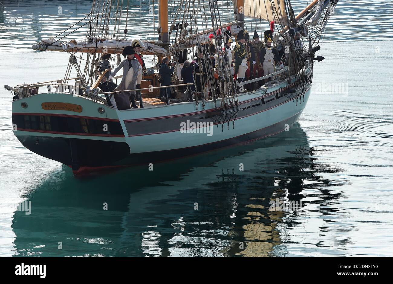 Italian enthusiast Roberto Colla, representing French Emperor Napoleon , stands on the ship 'Pandora' on February 22, 2015, leaving the harbour of Portoferraio on the island of Elba, Italy. The Italian island, where Napoleon was sent into exile in 1814, marks the 200th anniversary of the emperor leaving from Portoferraio and landing at the Golfe-Juan near Antibes,south of France, with enthusiast re-enacting the whole adventure. On February 28, 1814, British General Sir Neil Campbell realised with horror that his illustrious prisoner, Napoleon Bonaparte, had slipped away from the island of Elba Stock Photo