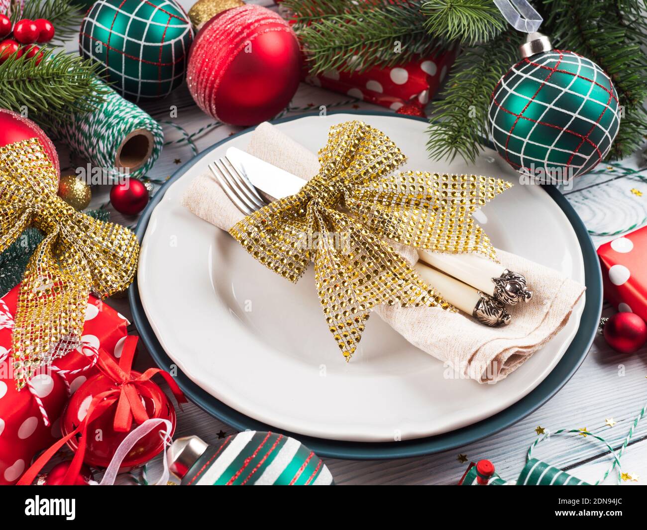 Christmas dinner table plate setting with decor Stock Photo Alamy