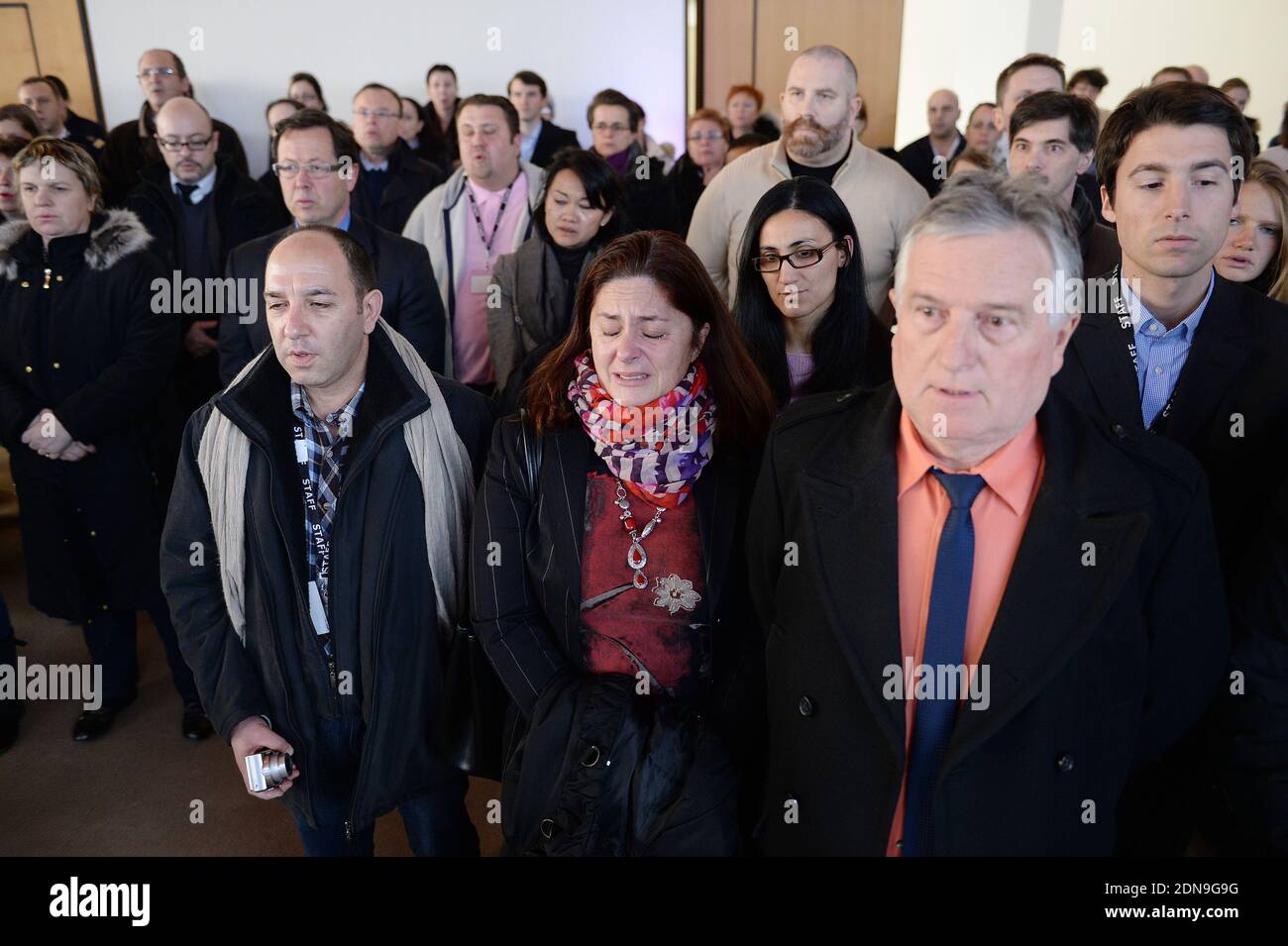 Employees of the French Embassy in Washington, DC, stand for a moment