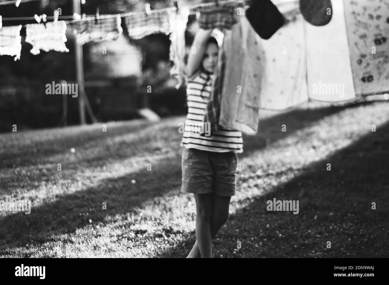 Girl Drying Clothes On Clothesline At Back Yard Stock Photo Alamy