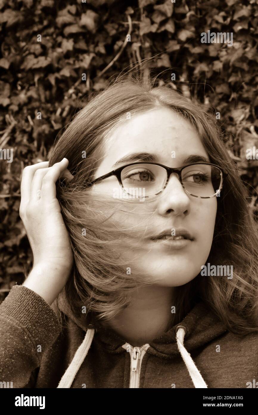 Close-up Of Girl Looking Away Against Plants Stock Photo