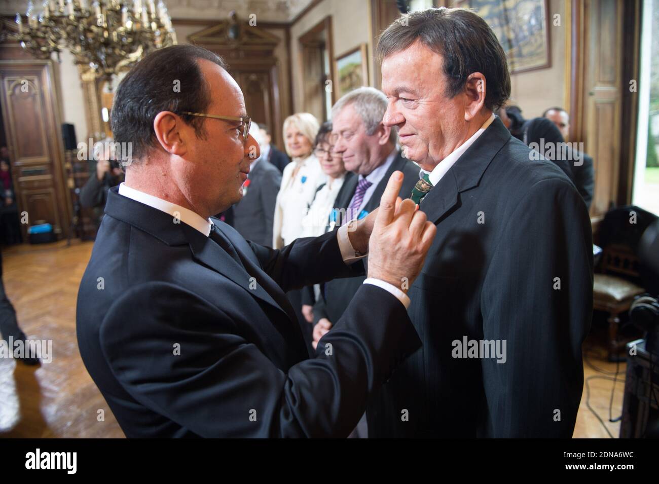 French President Francois Hollande holds a medal of Legion of Honor to Marc Boisseuil, Jean-Claude Boisdevesy, Pierre Mamers, Edith Perrier, Jean-Claude Talbert, Michelle Laurent-Bruzy, Patricia Broussole, Jean-Louis Chassaing, Fredy Dumas, during an award ceremony in Tulle, France, on January 17, 2015. Photo by Laurent Chamussy/Pool/ABACAPRESS.COM Stock Photo