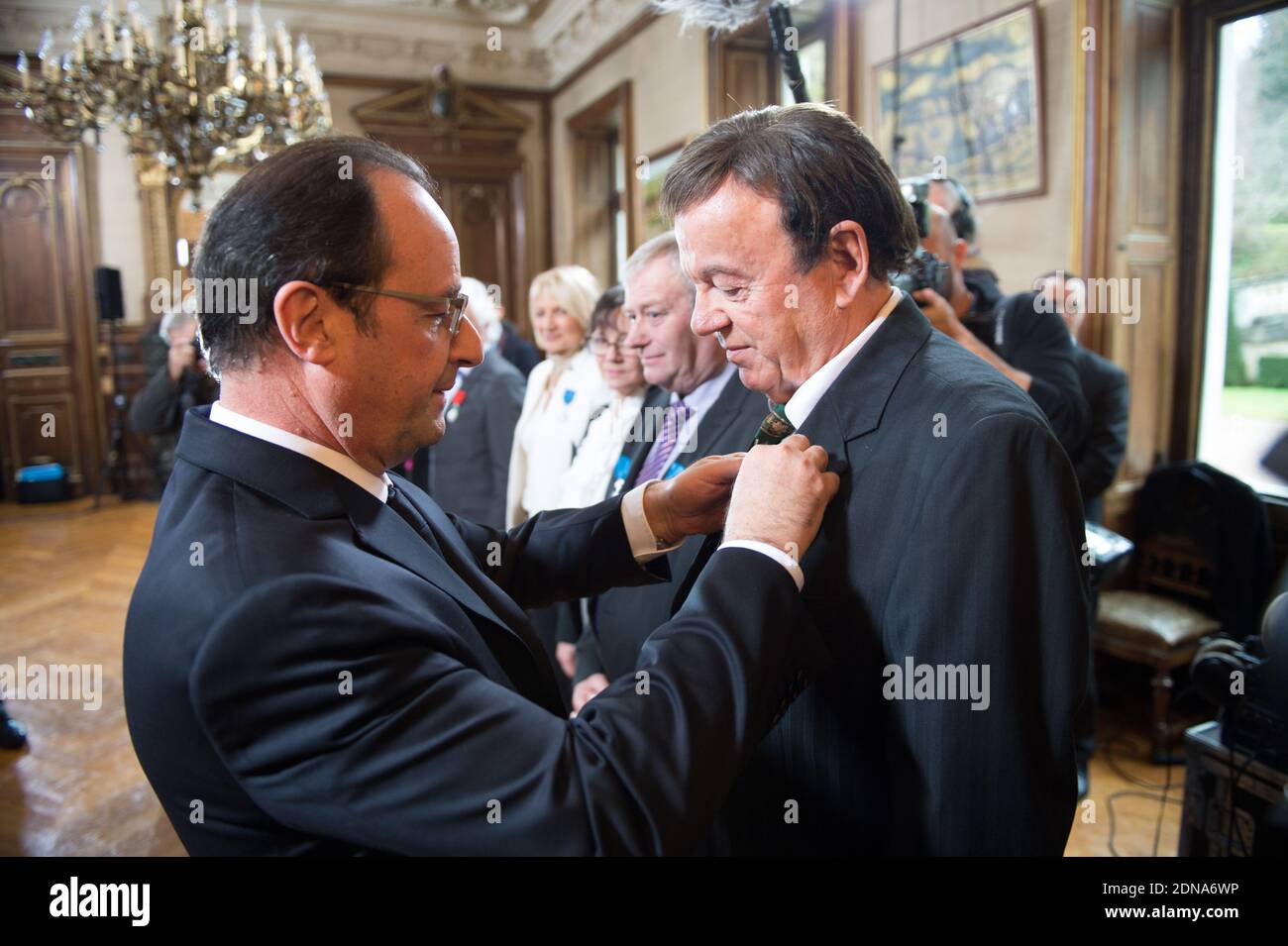 French President Francois Hollande holds a medal of Legion of Honor to Marc Boisseuil, Jean-Claude Boisdevesy, Pierre Mamers, Edith Perrier, Jean-Claude Talbert, Michelle Laurent-Bruzy, Patricia Broussole, Jean-Louis Chassaing, Fredy Dumas, during an award ceremony in Tulle, France, on January 17, 2015. Photo by Laurent Chamussy/Pool/ABACAPRESS.COM Stock Photo