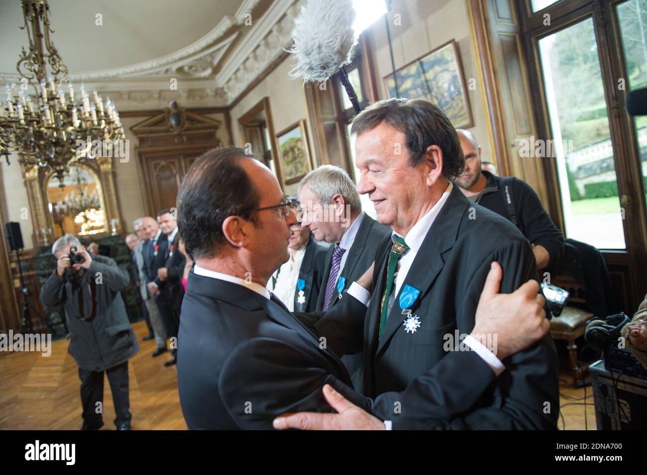 French President Francois Hollande holds a medal of Legion of Honor to Marc  Boisseuil, Jean-Claude Boisdevesy, Pierre Mamers, Edith Perrier, Jean-Claude  Talbert, Michelle Laurent-Bruzy, Patricia Broussole, Jean-Louis Chassaing,  Fredy Dumas, during an