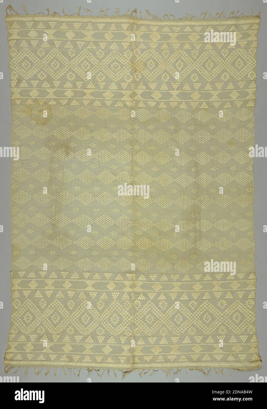Textile, Medium: cotton Technique: woven, Two lengths of sheer cotton seamed down longest edge. Spaced bands of lozenges and triangles inlaid with heavier cotton thread. Deep borders edged with openwork bands at either end. Twisted warp fringe., Albania, late 19th–early 20th century, woven textiles, Textile Stock Photo