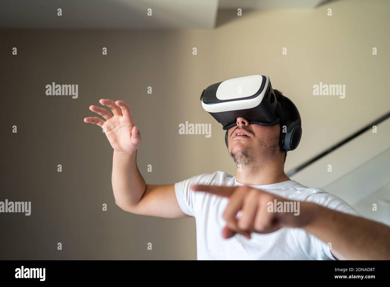 Young guy exited using virtual reality glasses Stock Photo