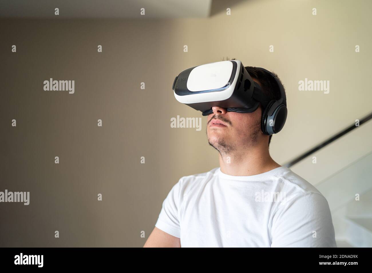 Young guy exited using virtual reality glasses Stock Photo