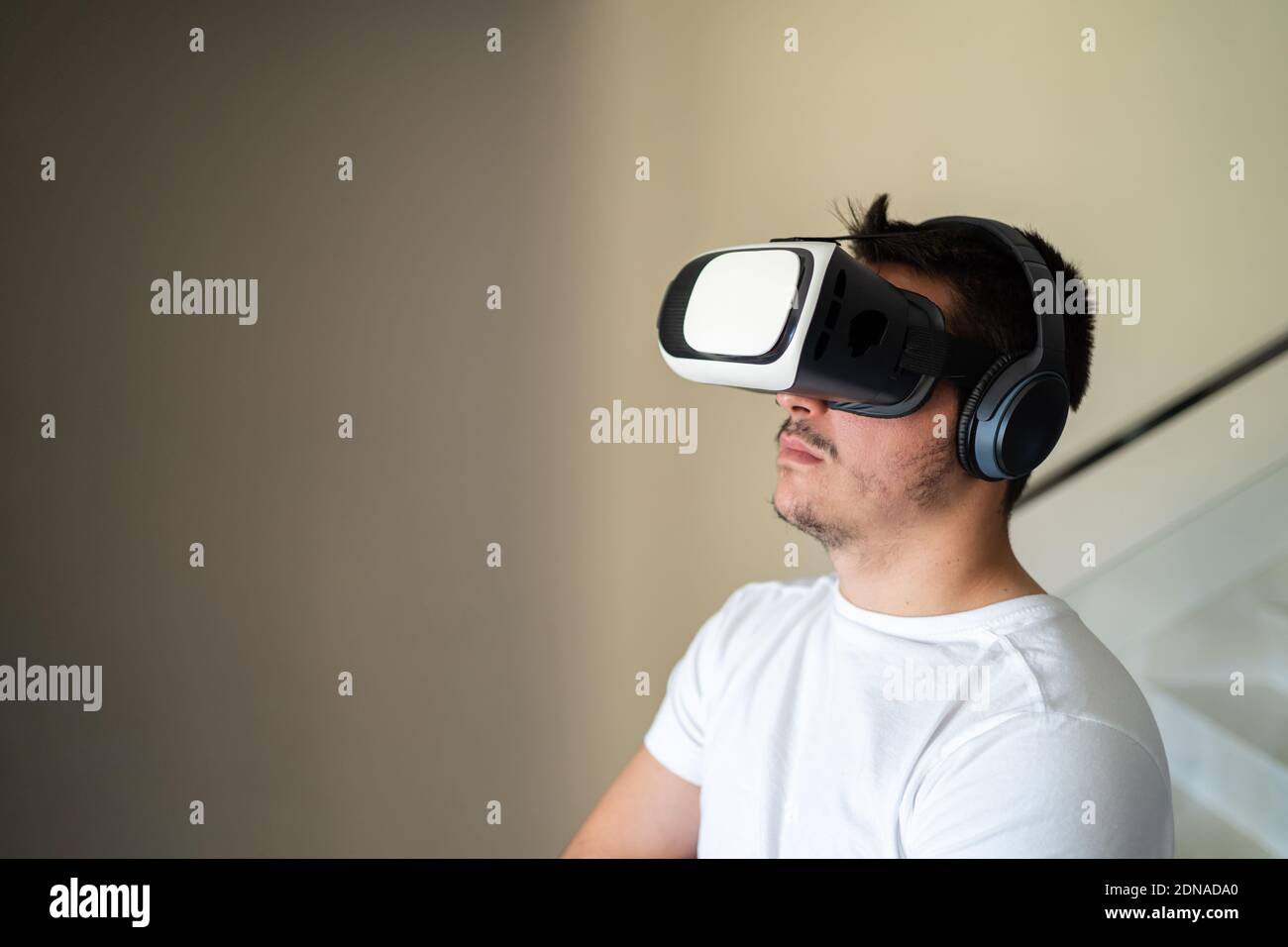 Young guy exited using virtual reality glasses Stock Photo