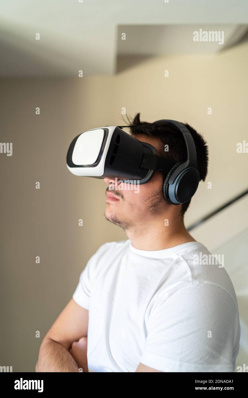 Young guy exited using virtual reality glasses Stock Photo