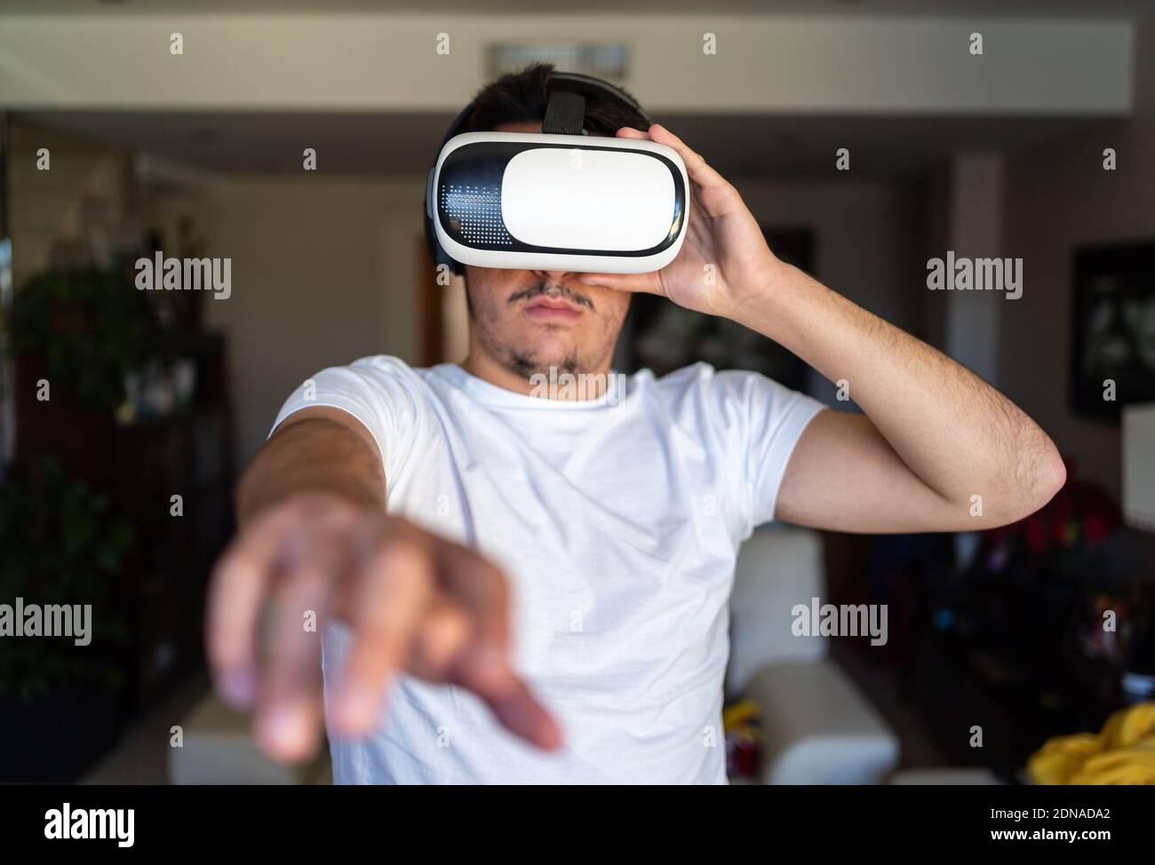 Young guy exited using virtual reality glasses Stock Photo