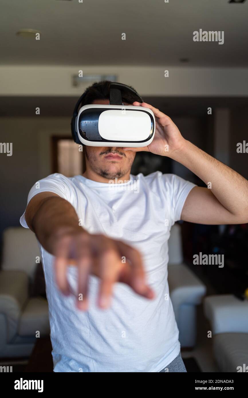 Young guy exited using virtual reality glasses Stock Photo