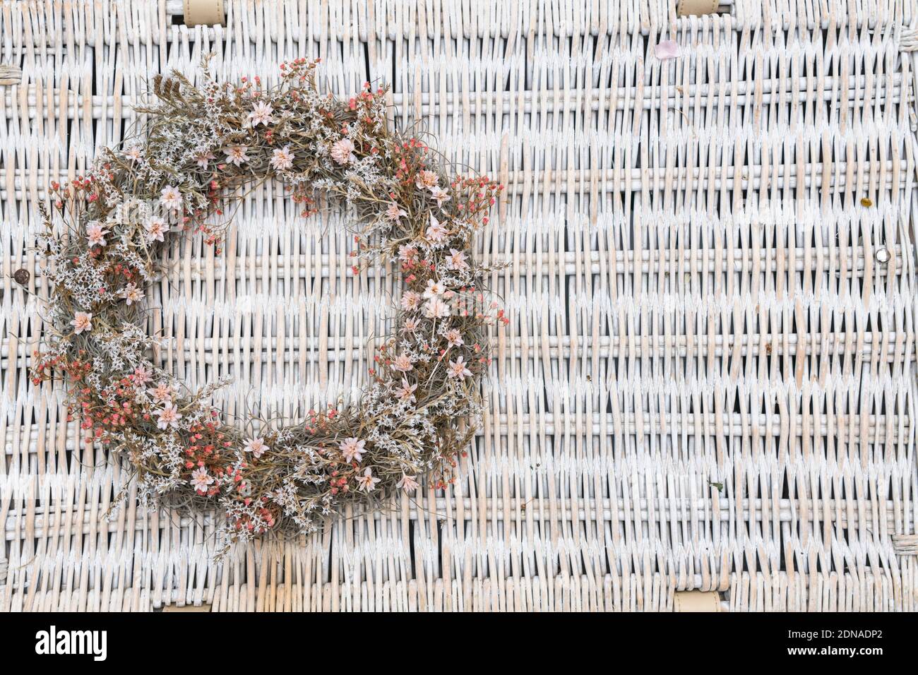 Beautiful, fashionable white and pale pink muted colours flower wreath on a plain background with copy space Stock Photo