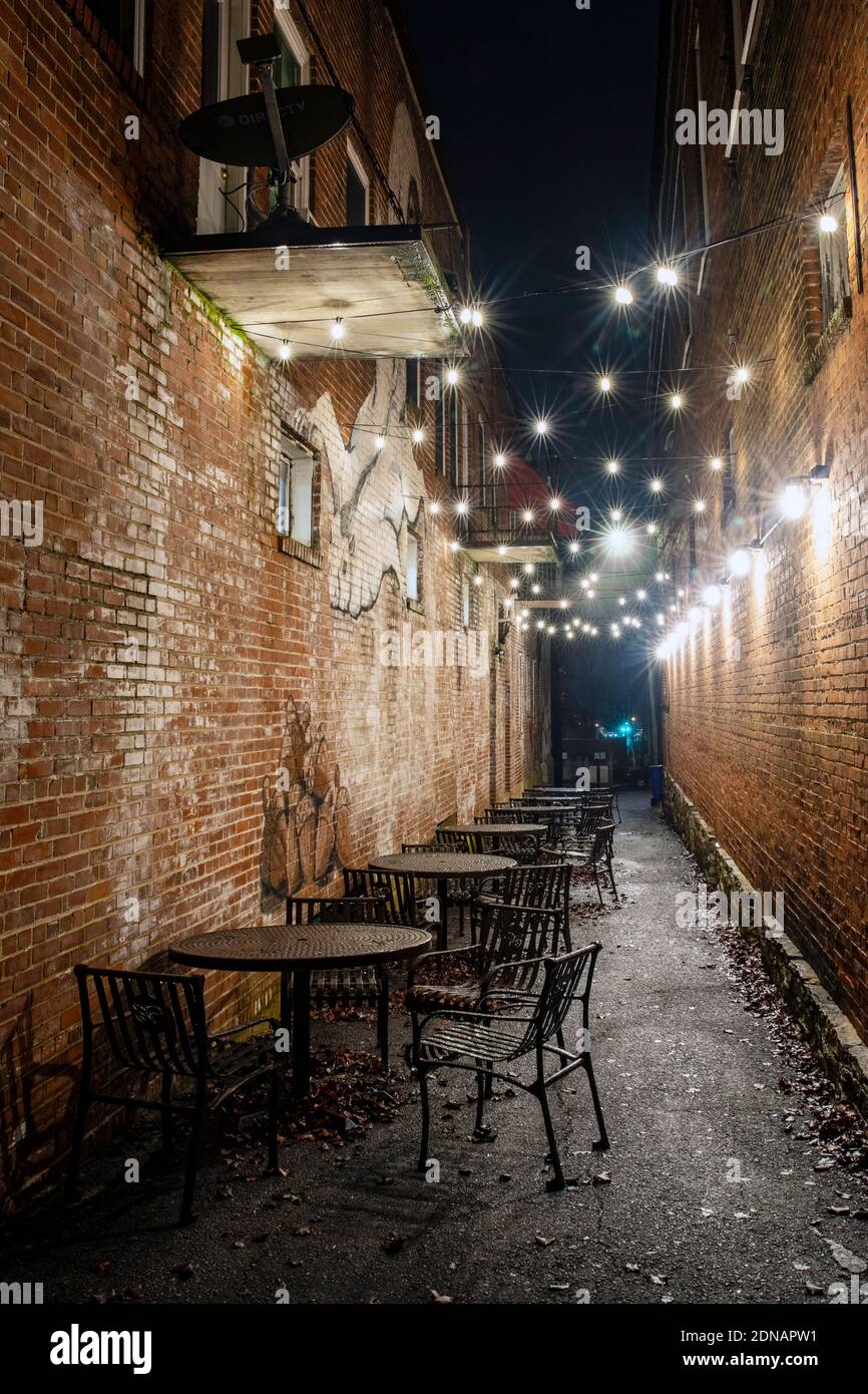 Outdoor seating and holiday lights in an alleyway downtown Brevard