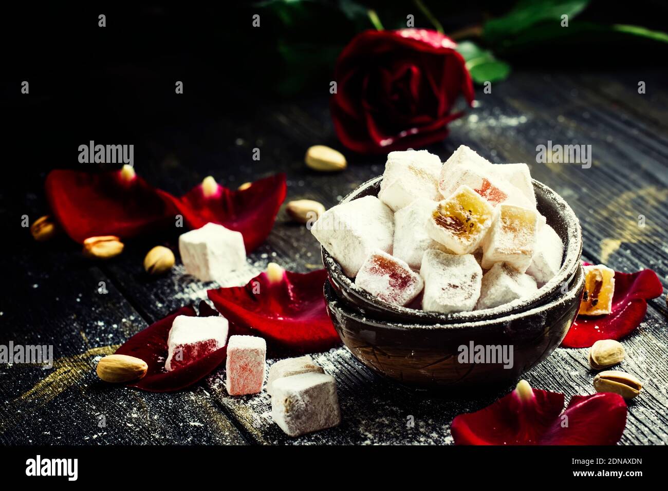 Rahat lukum, oriental sweets with pistachios and rose petals, low key, selective focus Stock Photo