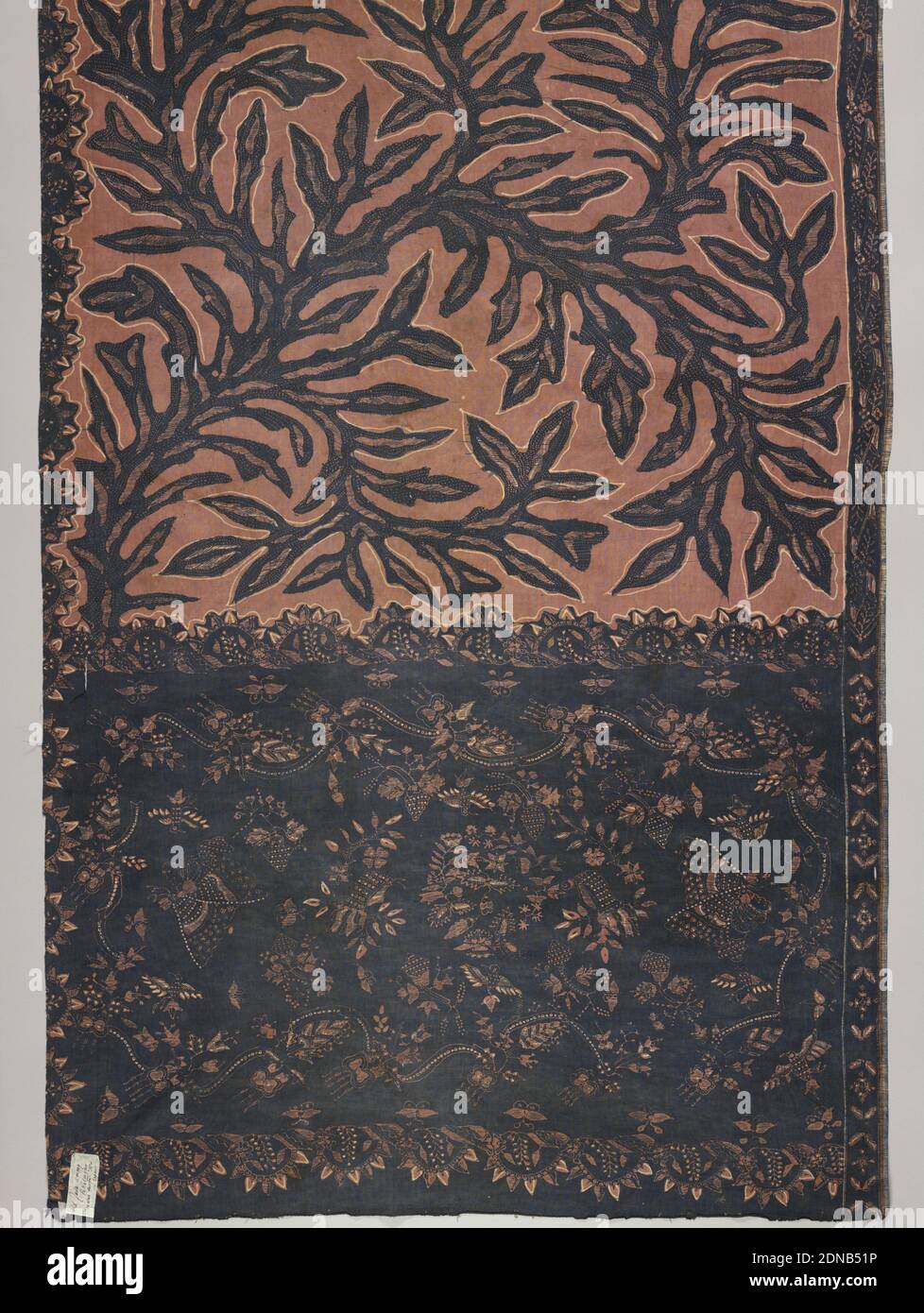 Sea Weed, Medium: cotton Technique: wax resist dyeing (batik) on plain weave, Batik sarong in brown, pink, and dark blue. Dark blue seaweed pattern placed freely over the pink-brown ground in the body or 'badan' of the piece. The head or 'kepala' (broad band with different coloring and pattern than remainder) shows dark ground with floral pattern., Pekalongan, Indonesia, 19th century, printed, dyed & painted textiles, Sarong, Sarong Stock Photo