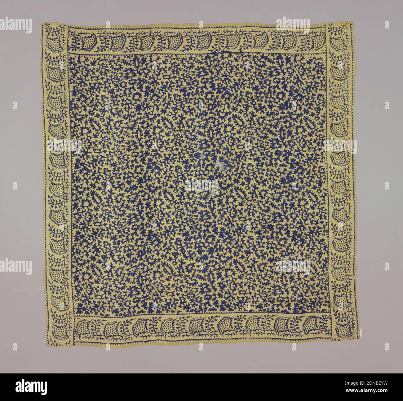 Square, Medium: silk Technique: printed, Yellow square with highly conventionalized design of plant forms in dark blue. Initials IAW embroidered in tiny red cross stitch in one corner., India, late 19th century, printed, dyed & painted textiles, Square Stock Photo