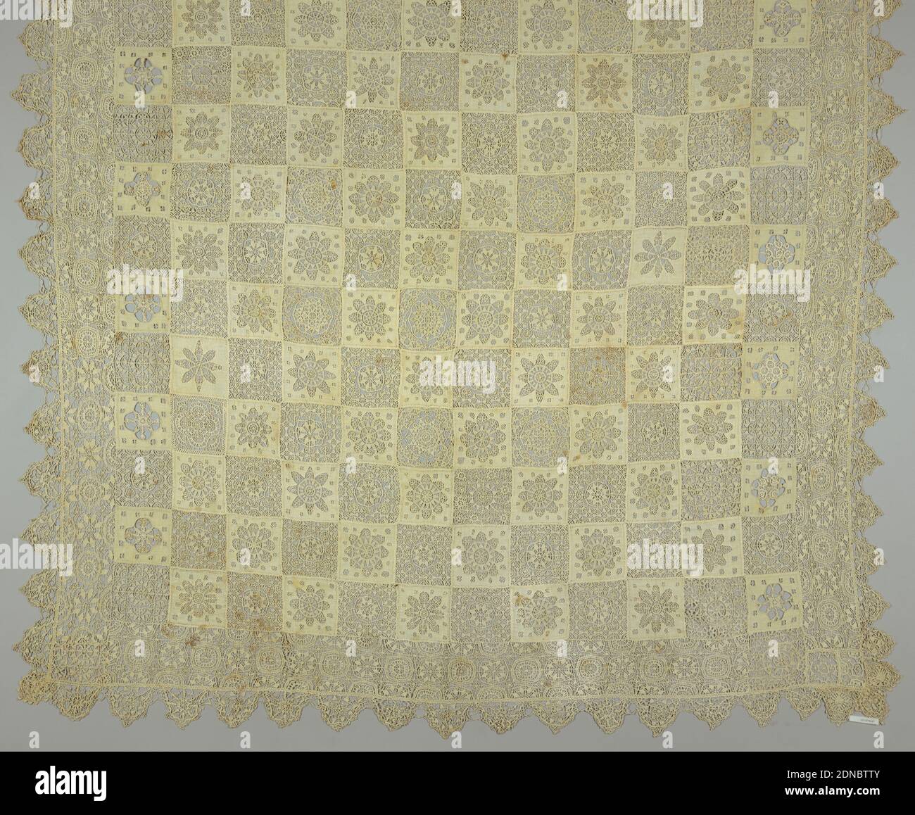 Tablecover, Medium: linen Technique: cutwork, needle lace and needlework on knotted net, Checkerboard arrangement of squares of punto in aria with geometric motifs alternating with squares of fabric which have rosettes cutouts filled in with needlelace. Border of punto in aria. Scalloped needlelace edging., Europe, 19th century, lace, Tablecover Stock Photo