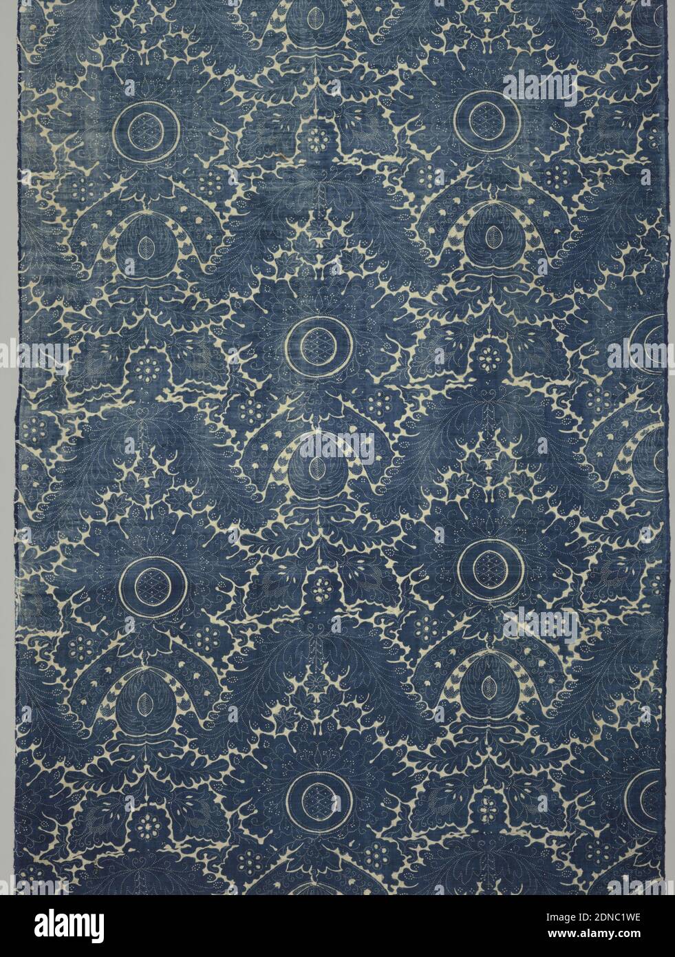 Textile, Medium: cotton Technique: block printed using resist, then vat dyed in indigo on plain weave, Pomegranate-like shapes within a frame of arching leaves. Two repeats across width. In blue on white., France, 1750–1800, printed, dyed & painted textiles, Textile Stock Photo