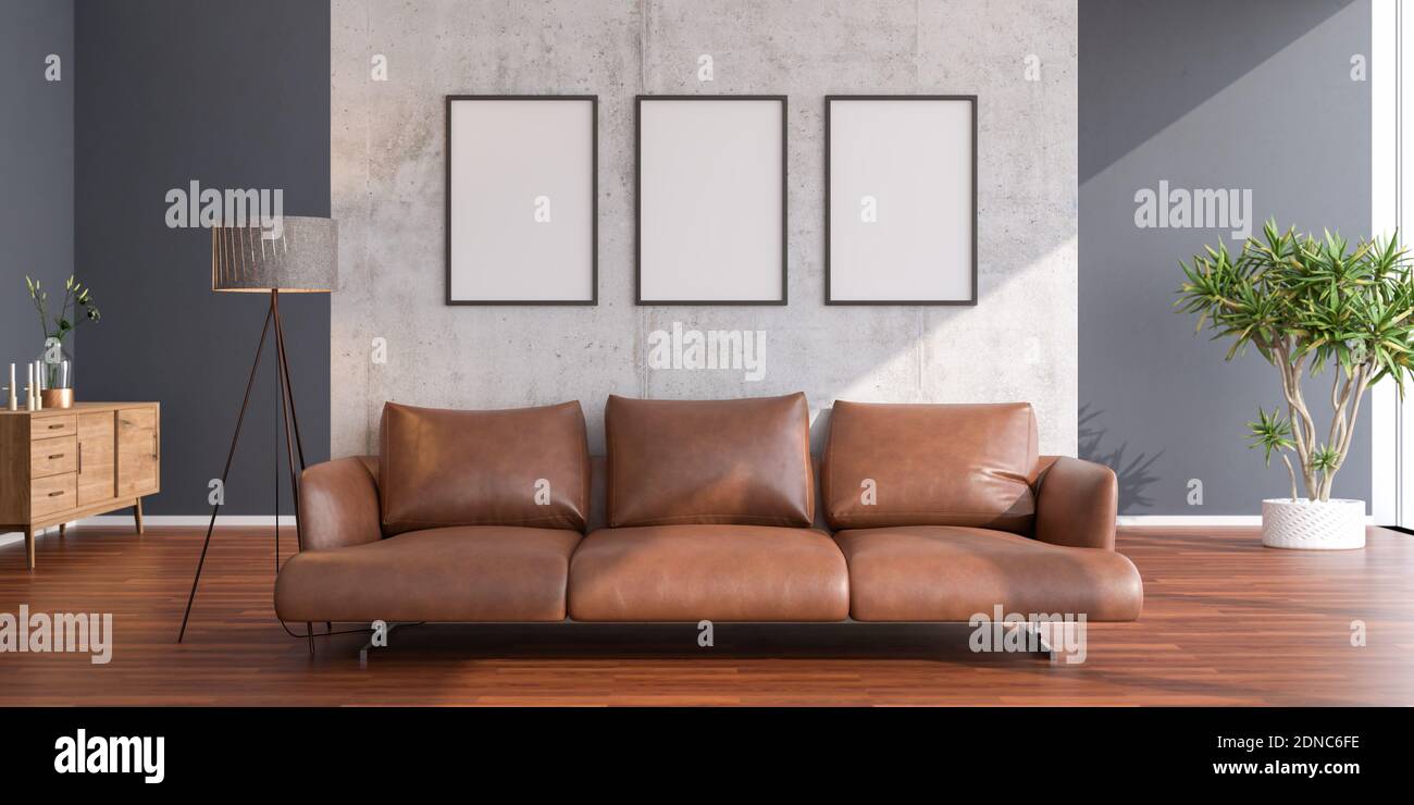 Brightly lit living room with leather sofa in front of concrete room divider. Three picture frame mockups in 70x100cm. Stock Photo