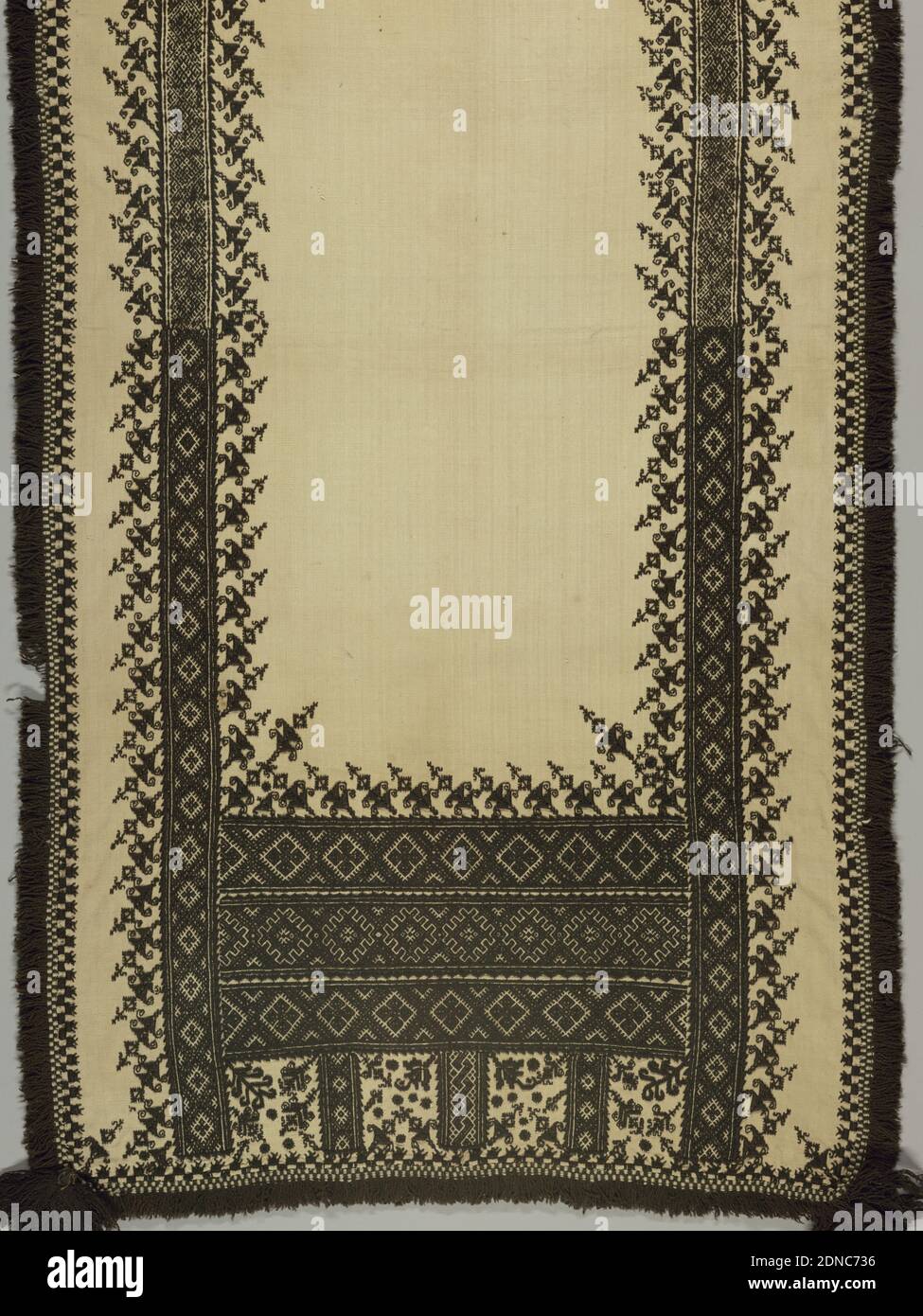 Panel, Medium: linen, wool Technique: embroidered in cross and satin stitch, Oblong panel of heavy cream white hand-woven linen embroidered in black wool and trimmed with fringe of black wool and black tassels at each corner. Borders at side and deep border at end, with a highly stylized plant form, detached and placed at a slant, above borders of geometric forms. Cross and satin stitch., Spain, 18th–early 19th century, embroidery & stitching, Panel Stock Photo