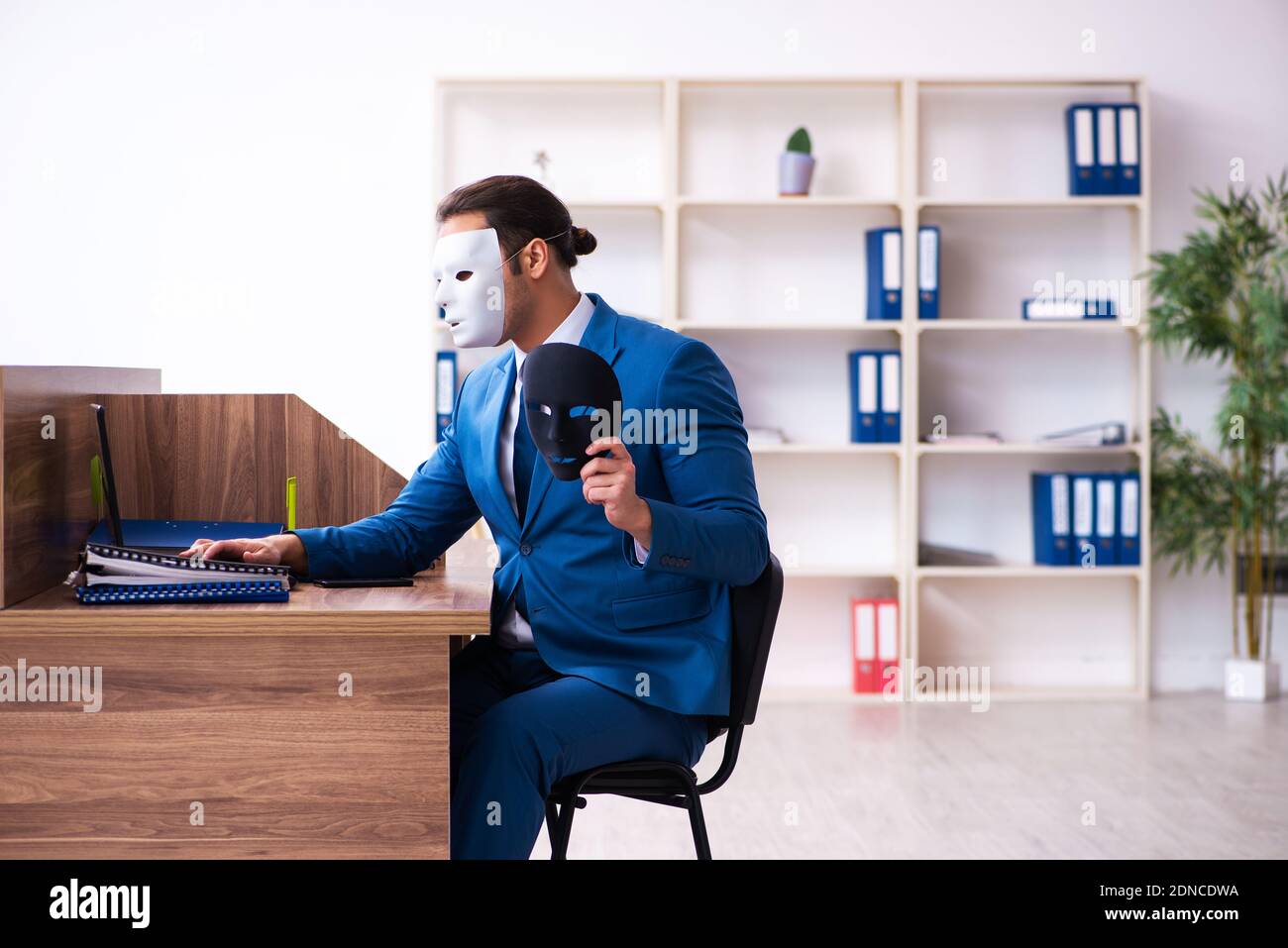 Young employee wearing mask in the office Stock Photo - Alamy