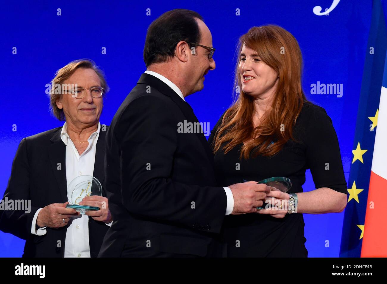 French President Francois Hollande presents producer Marie-Castille Mention-Schaar with a CRIF award as director Alexander Arcady looks on during the 30th annual Dinner of the Representative Council of the Jews of France (CRIF) held at the Pullman Montparnasse Hotel in Paris, France on February 23, 2015. Photo Pool by Erez Lichtfeld/ABACAPRESS.COM Stock Photo