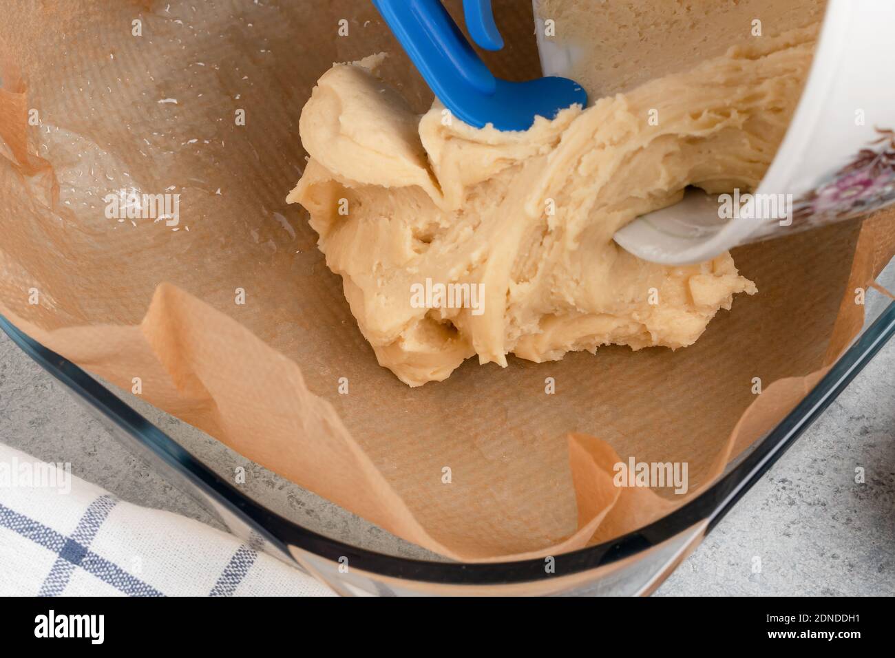 Putting the pie dough into a baking dish Stock Photo