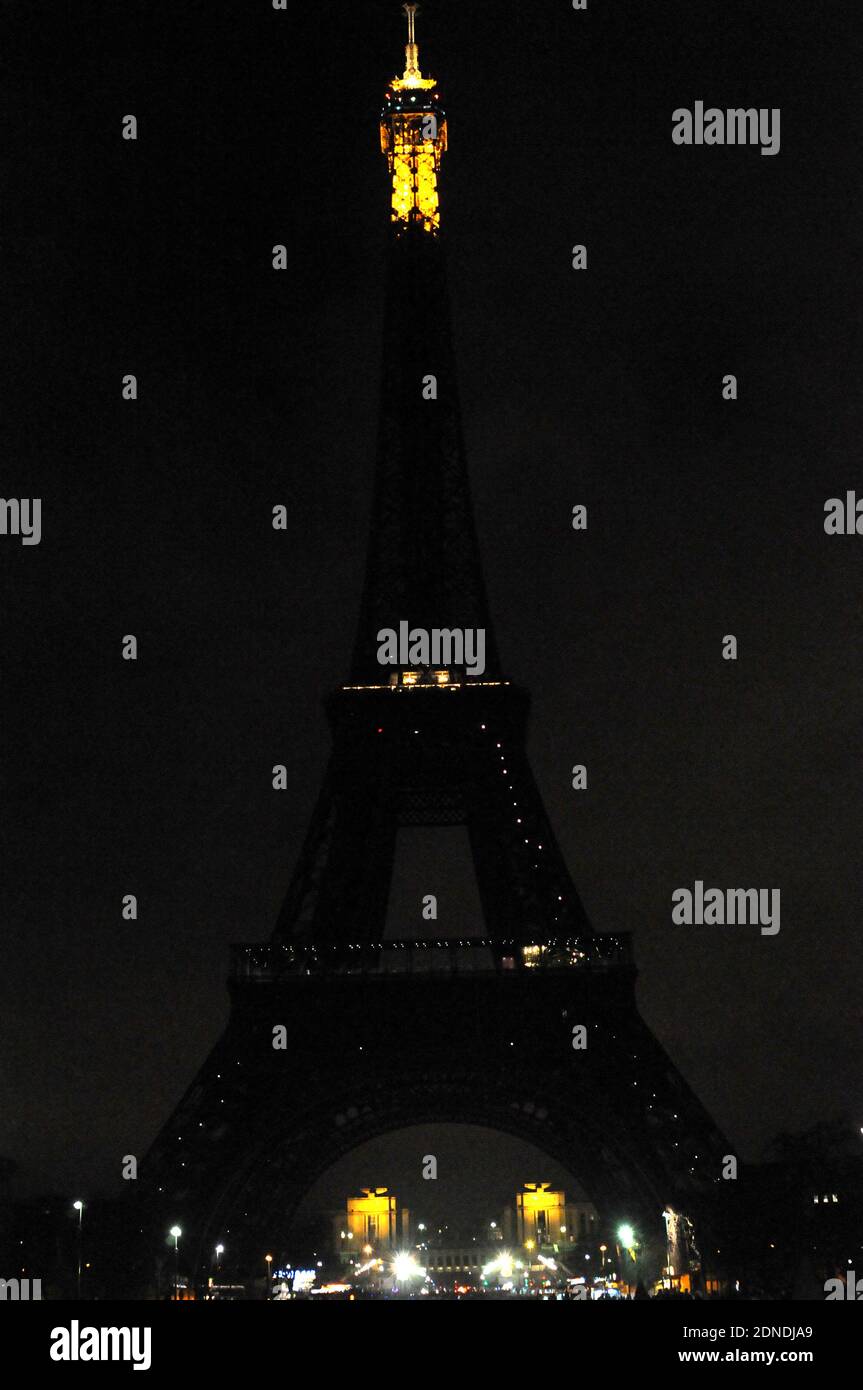 The Eiffel Tower is seen in darkness to mark the WWF's Earth Hour, raising awareness about climate change. Paris, France, Saturday March 28, 2015. The event has seen more than 700 landmarks around the world switch off their lights. Photo by Alain Apaydin/ABACAPRESS.COM Stock Photo