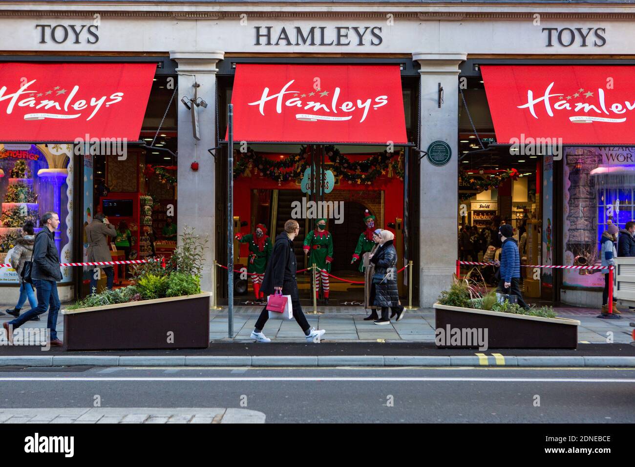 Hamleys Elves greet people in the toy store in Reagent Street.Non-essential shops are still allowed to stay open in Tier 3 areas.  Many retailers will still be open for all Christmas shopping needs. Stock Photo