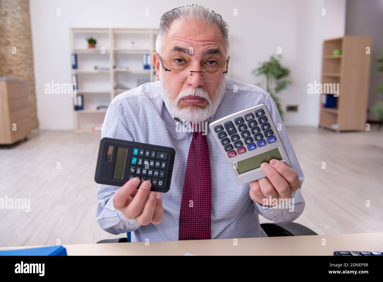 Senior accountant in budget planning concept in the office Stock Photo