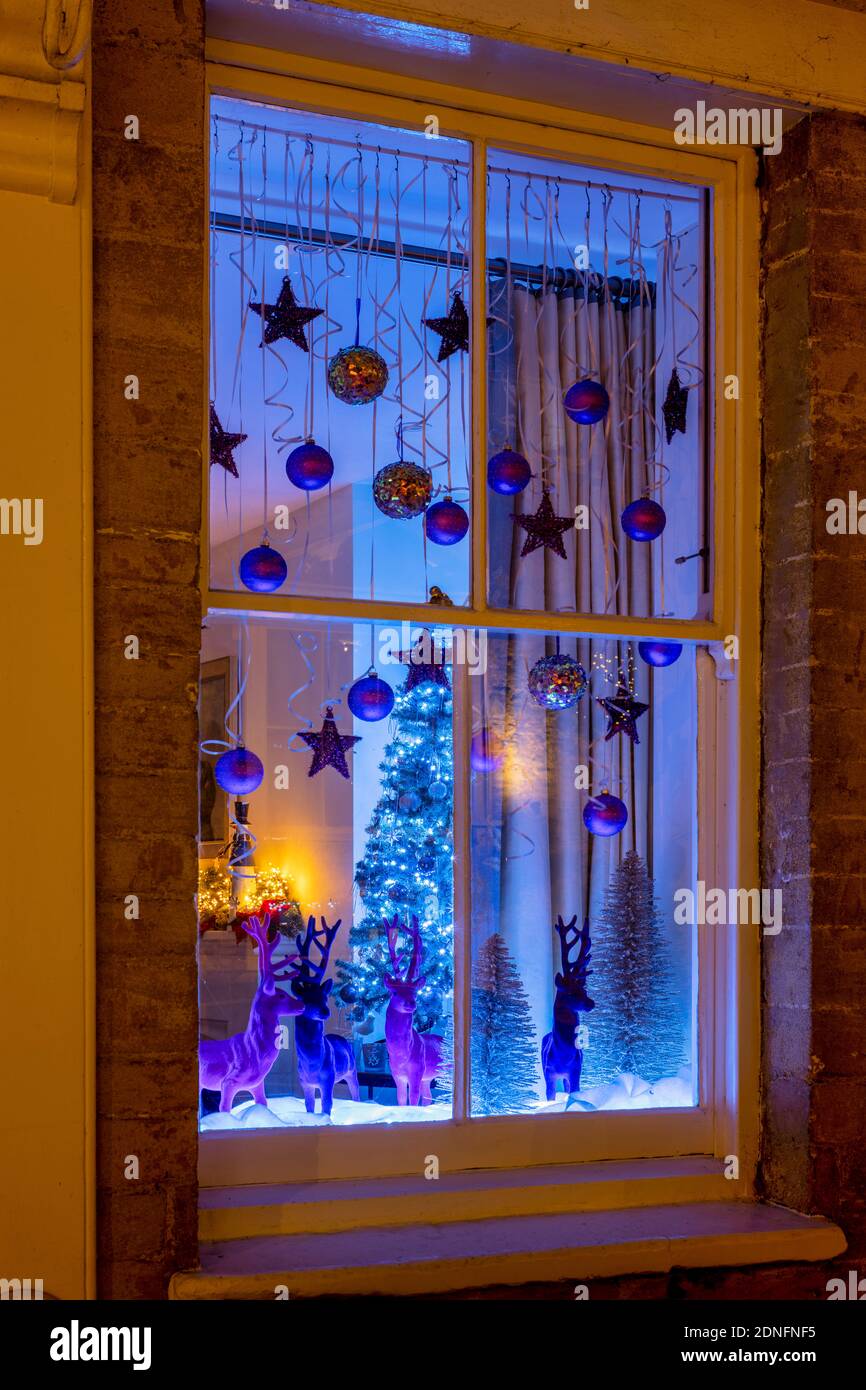 Christmas decorations in a Woodstock house window at night. Woodstock, Oxfordshire, England Stock Photo