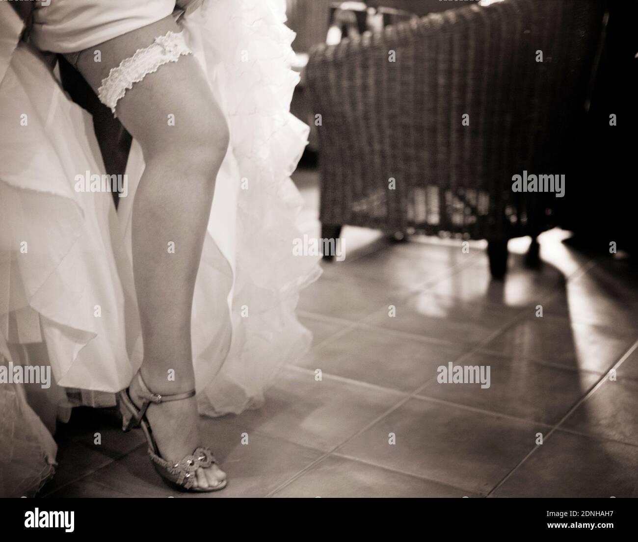 Low Section Of Bride Wearing Garter Belt On Floor Stock Photo Alamy