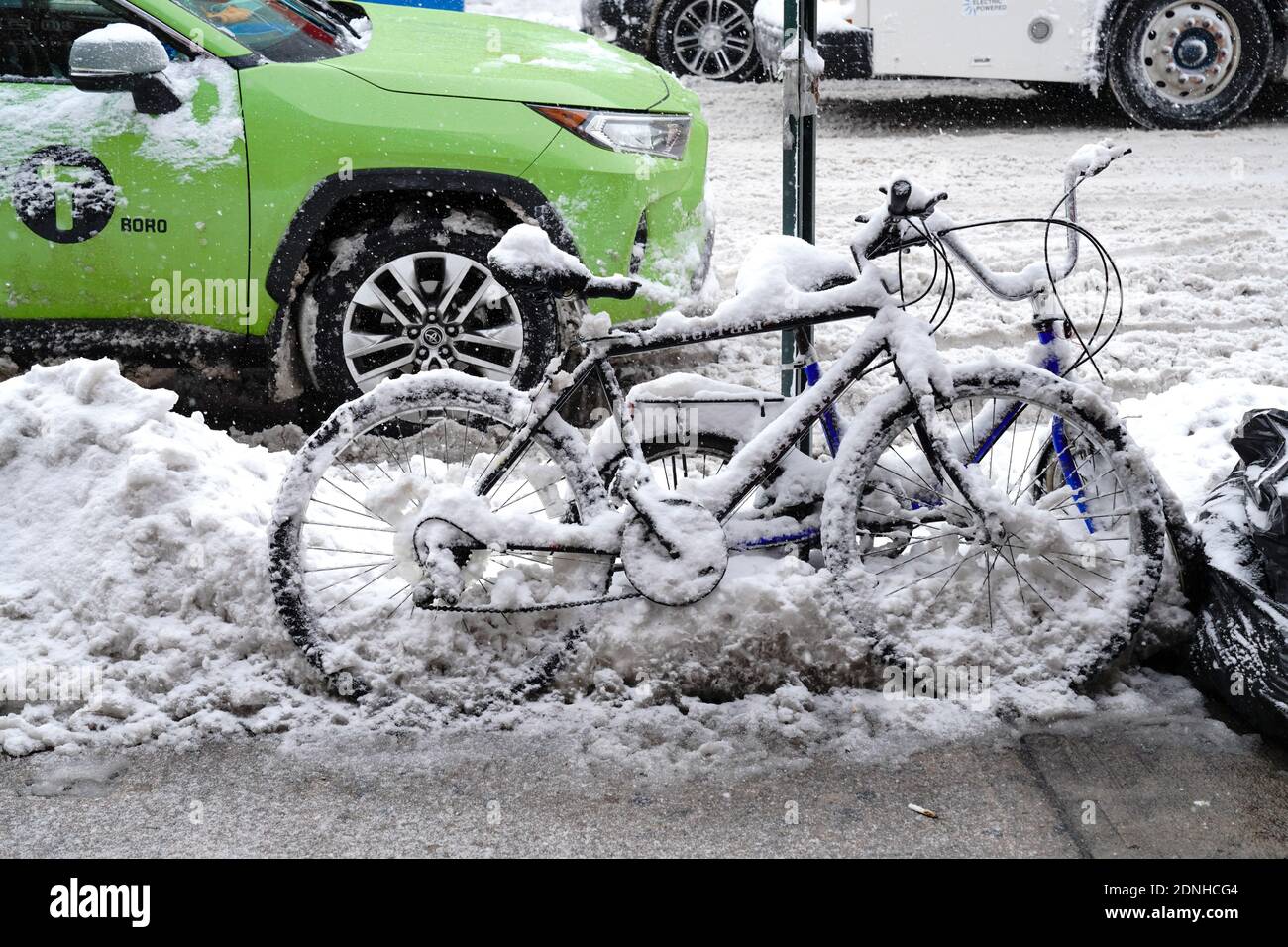 A view of snow-covered bicycles.The morning after a powerful winter storm hit the US northeastern states, a major snowstorm hit the US east coast during Thursday's early hours, creating extra challenges in the midst of a coronavirus pandemic and a mass vaccination rollout taking place across the region. The winter storm, moving over New York, Pennsylvania and other northeastern states, leaves millions facing more than a foot of snow a week before Christmas, potentially disrupting coronavirus testing and delaying holiday deliveries. It also left more than 60 million people under bad weather war Stock Photo
