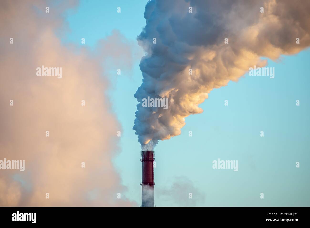 Environmental pollution and the problem of global warming due to the release of carbon dioxide into the atmosphere from the chimney of factories Stock Photo