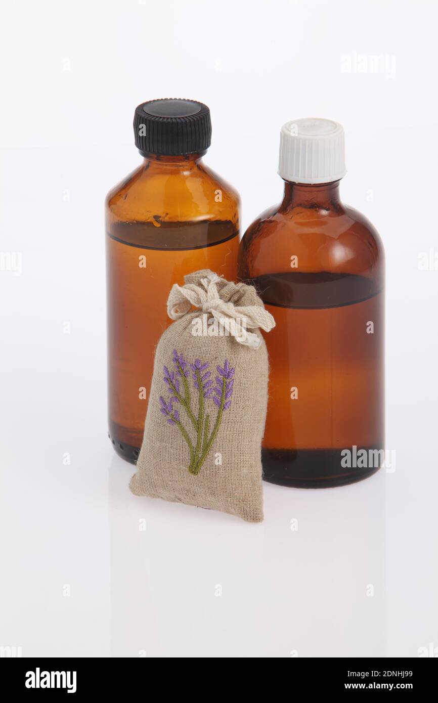 Massage Oil In Bottles By Sack Against White Background Stock Photo - Alamy