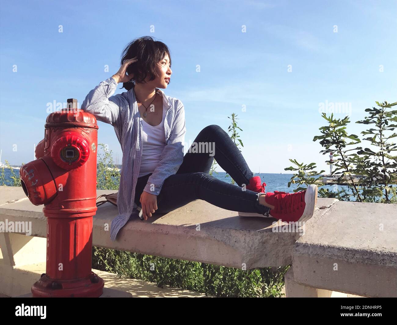 Woman sitting on fire hydrant High 