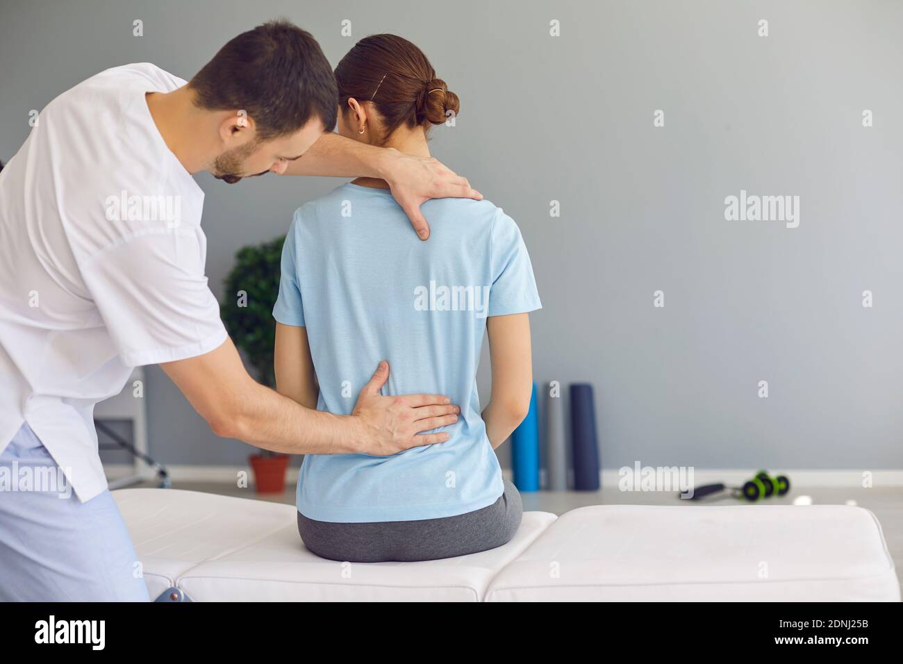 Professional osteopath fixing woman patients back muscles during rehabilitation theapy Stock Photo