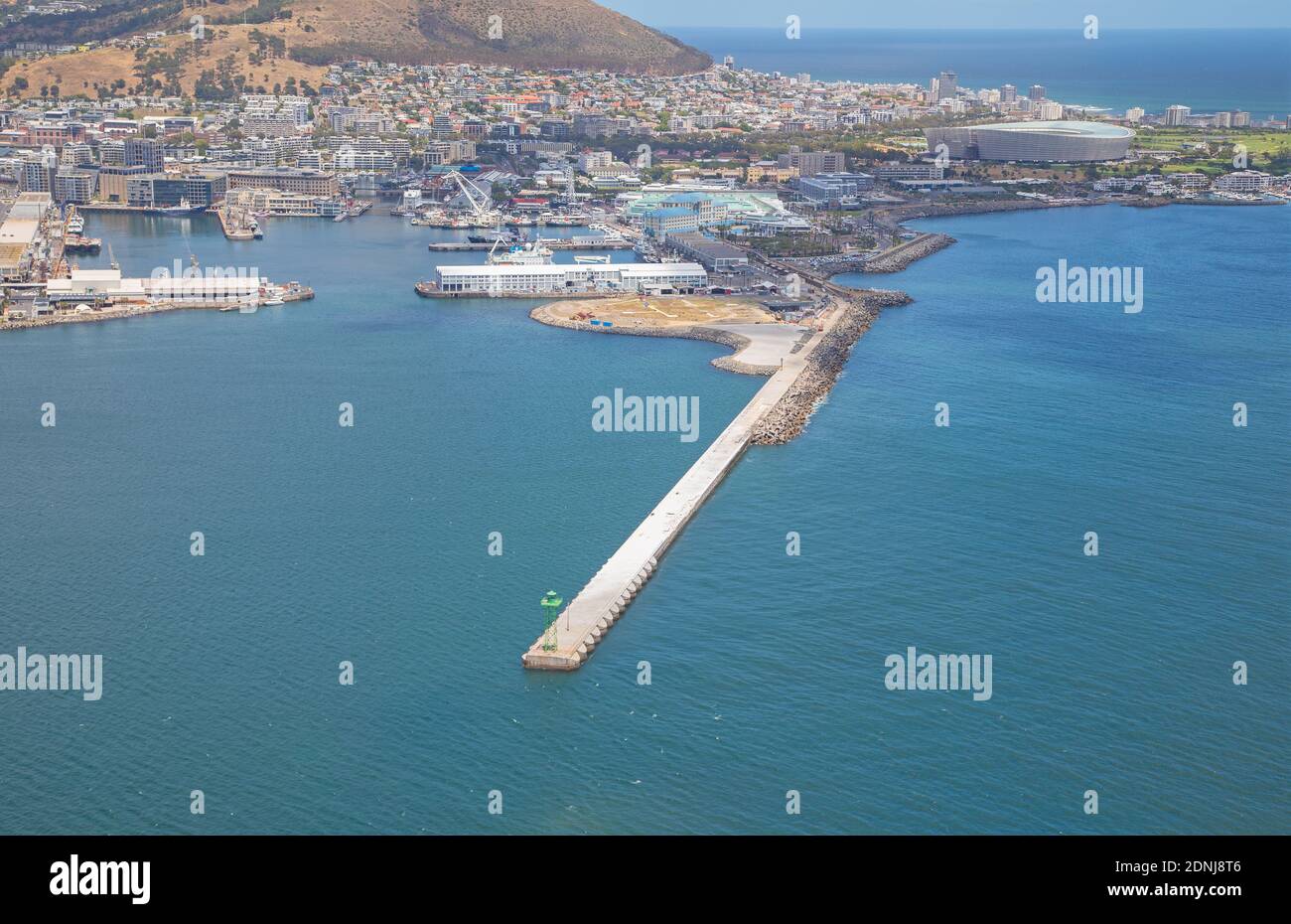 Cape Town, Western Cape / South Africa - 11/26/2020: Aerial photo of V&A Waterfront helipads and breakwater with Cape Town 2010 Stadium in the backgro Stock Photo
